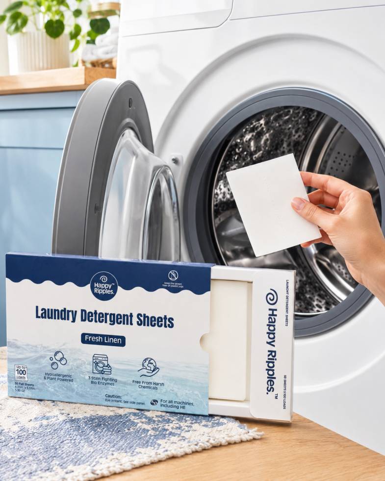 Happy Ripples Fresh Linen laundry detergent sheet being placed into a washing machine