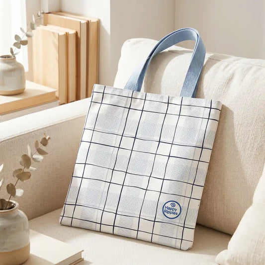 Happy Ripples checkered tote bag with blue handles on a beige armchair.
