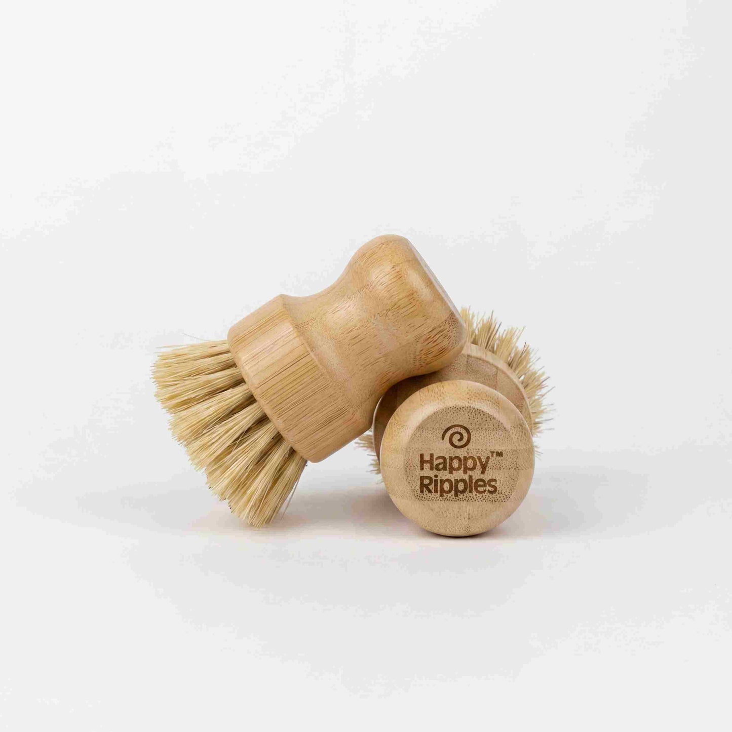 A natural bristle dish brush with a wooden handle on a neutral background